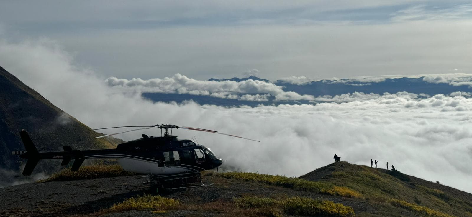 Capital Helicopters Bell above the clouds in the Yukon