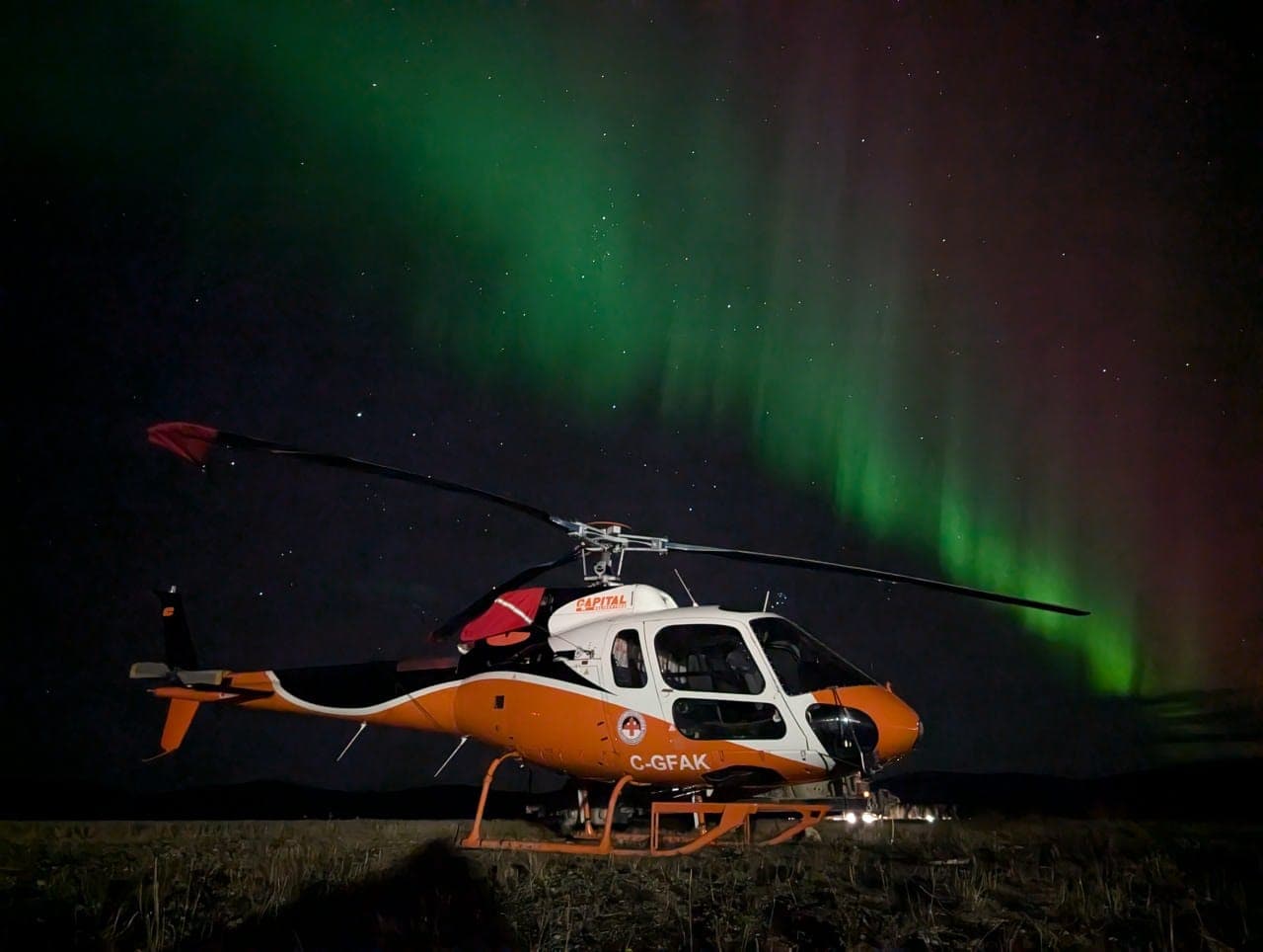 Capital Helicopters AS350 under the aurora borealis in the Yukon